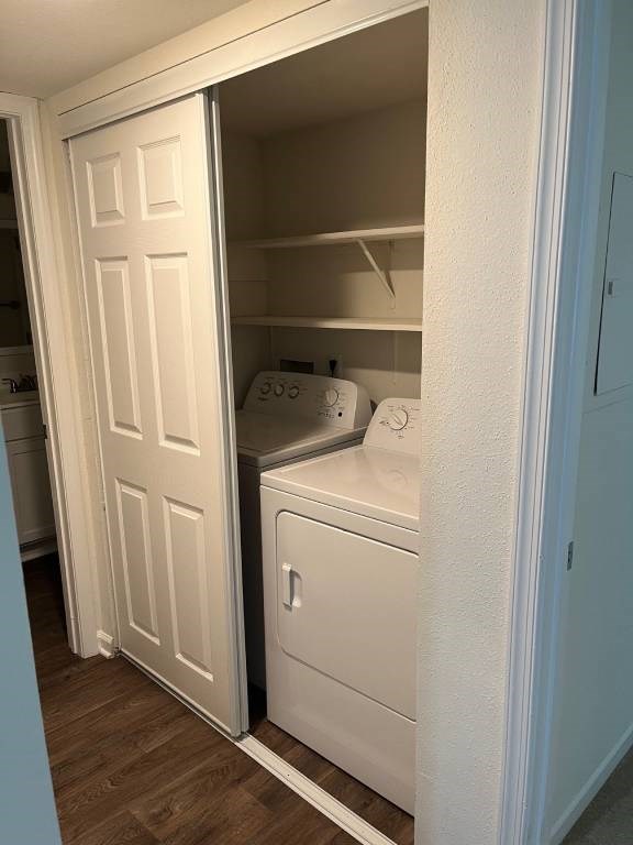 A white door is open to reveal a small kitchen with a washing machine.