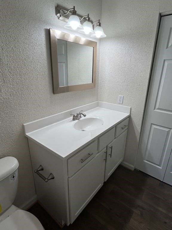 A bathroom with a white sink and a mirror above it.