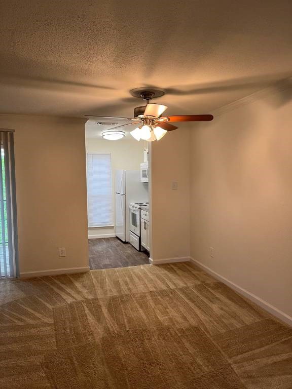 A room with a fan and a carpet.
