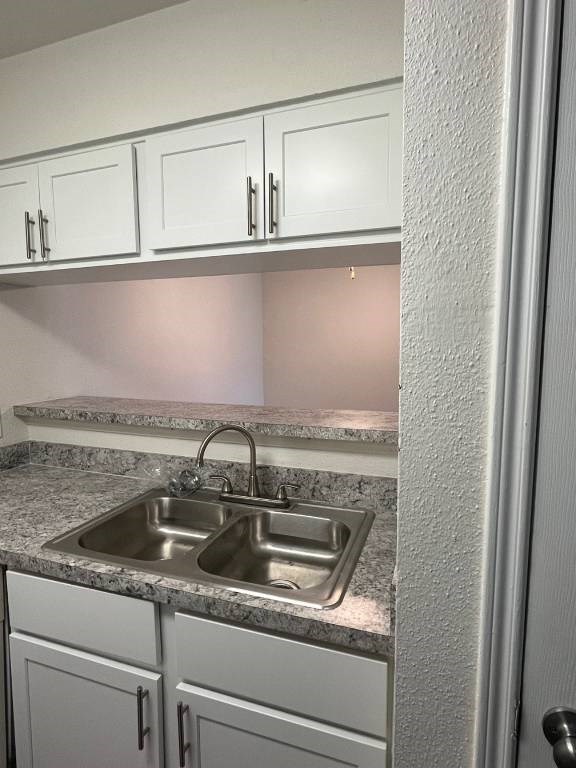 A kitchen with a sink and cabinets.