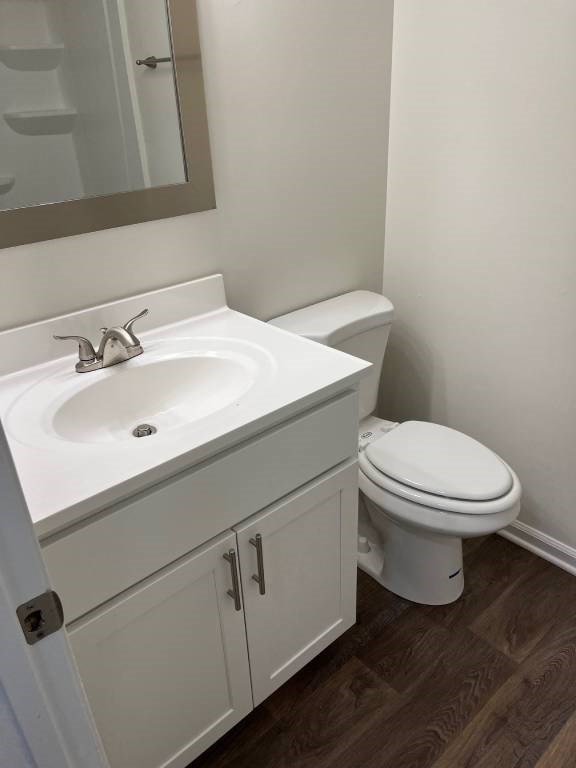 A white toilet sits next to a sink in a bathroom.