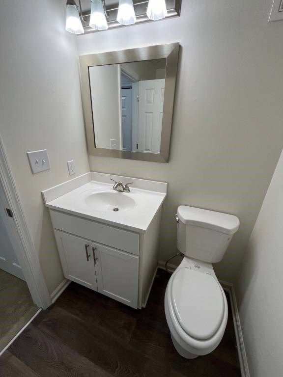 A white toilet sits next to a sink in a small bathroom.