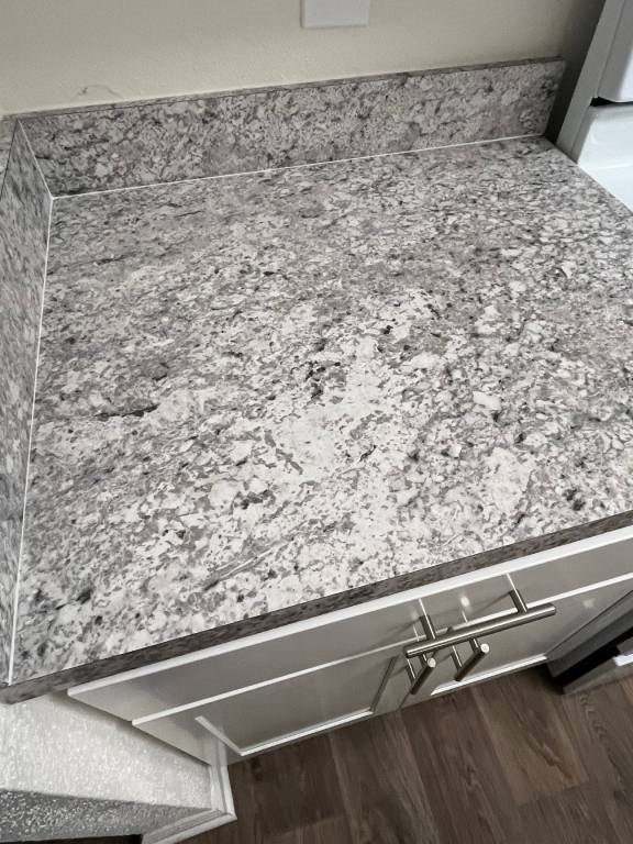 A granite countertop with a silver drawer underneath.