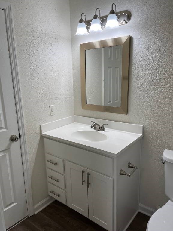 A white bathroom with a sink and mirror.