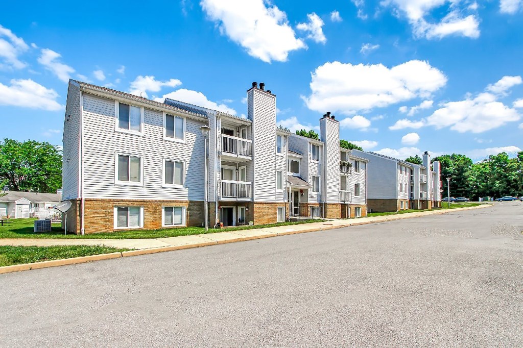 A row of modern apartment buildings with a clear blue sky above.