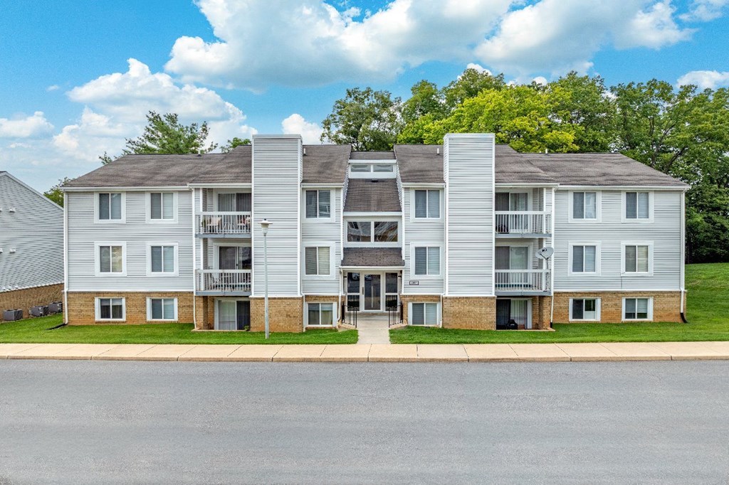 A large apartment complex with multiple balconies and doors.