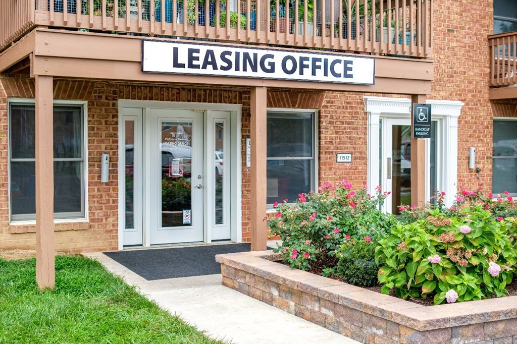 A building with a sign that says "LEASING OFFICE" above the door.