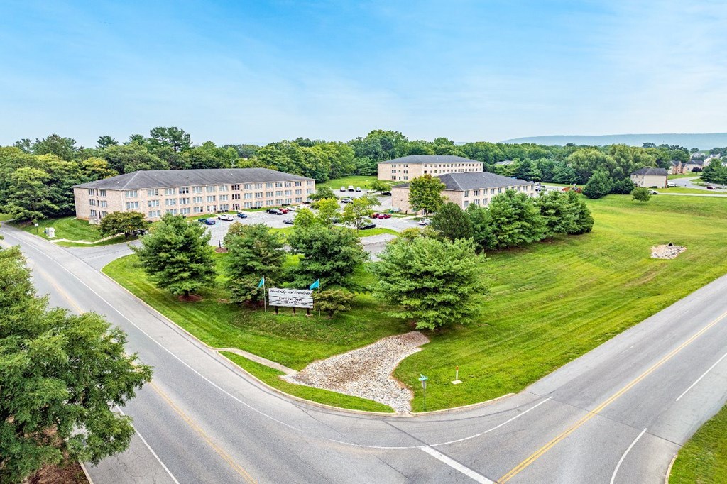 A large building with a parking lot in front of it.