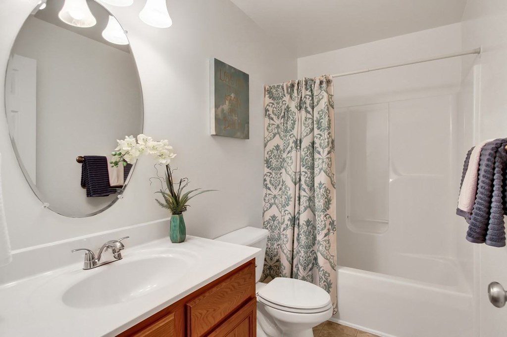 A bathroom with a white sink and a white toilet.