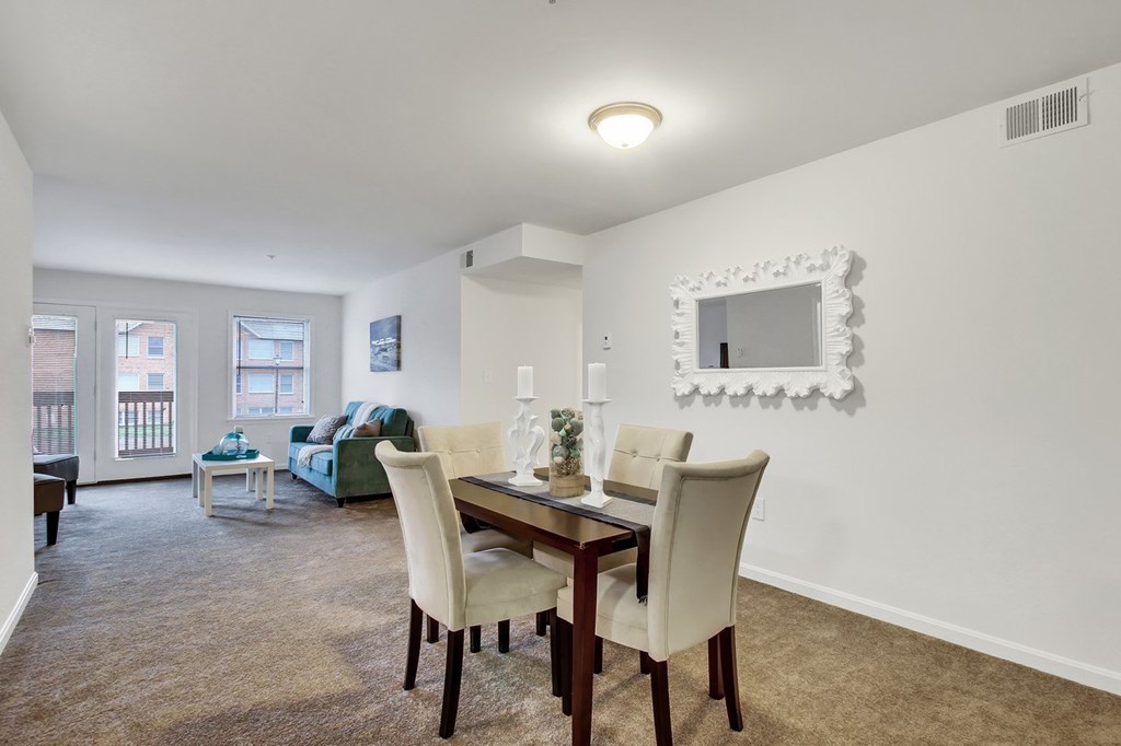 A dining room with a table and chairs.
