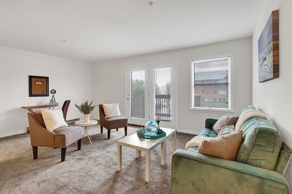 A living room with a green couch and a coffee table.