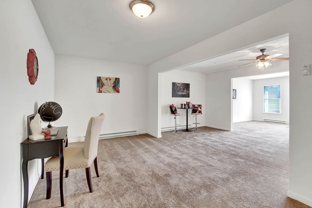 A room with a desk and chair in it.