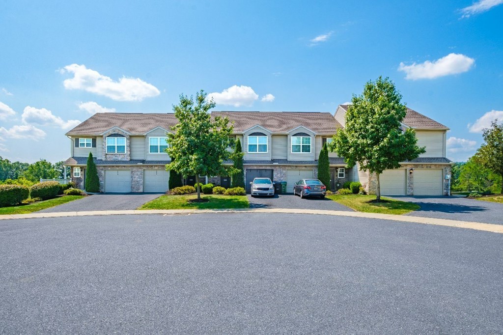 A large house with a driveway in front of it.