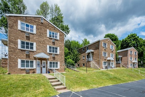 A large brick building with a white door and windows.