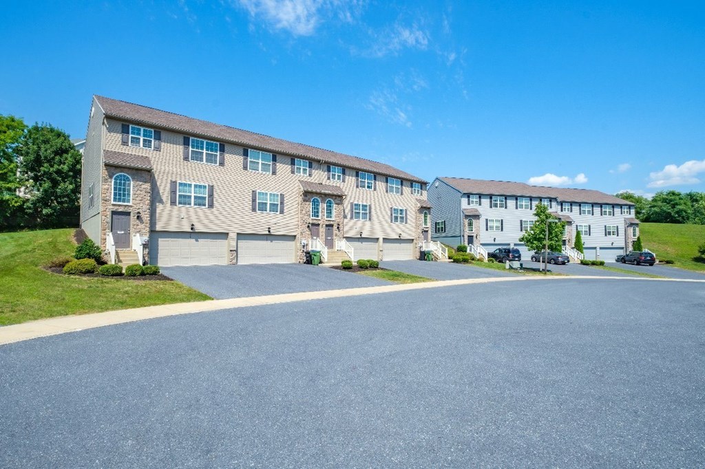 A large building with a parking lot in front.