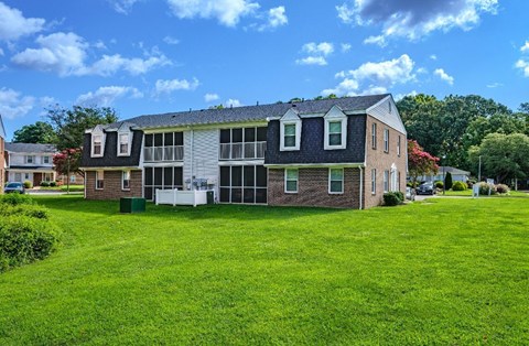 A large house with a green lawn in front.