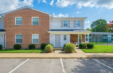 A row of houses with a clear blue sky above them.