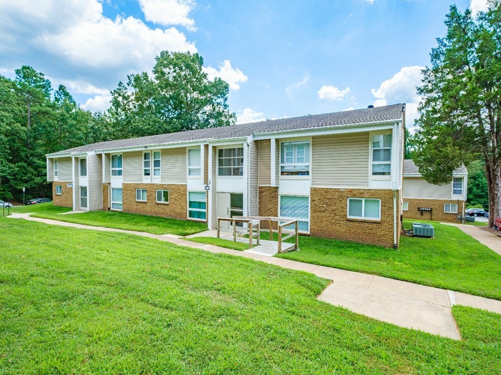 Apartment complex with a green lawn in front.