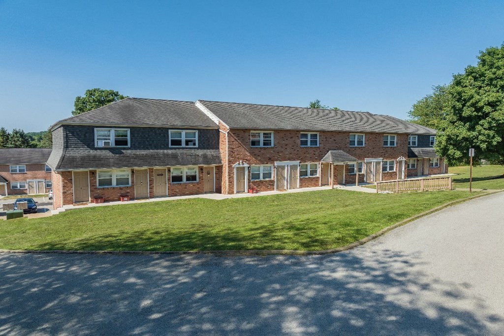 A large brick building with a curved roof and multiple windows.