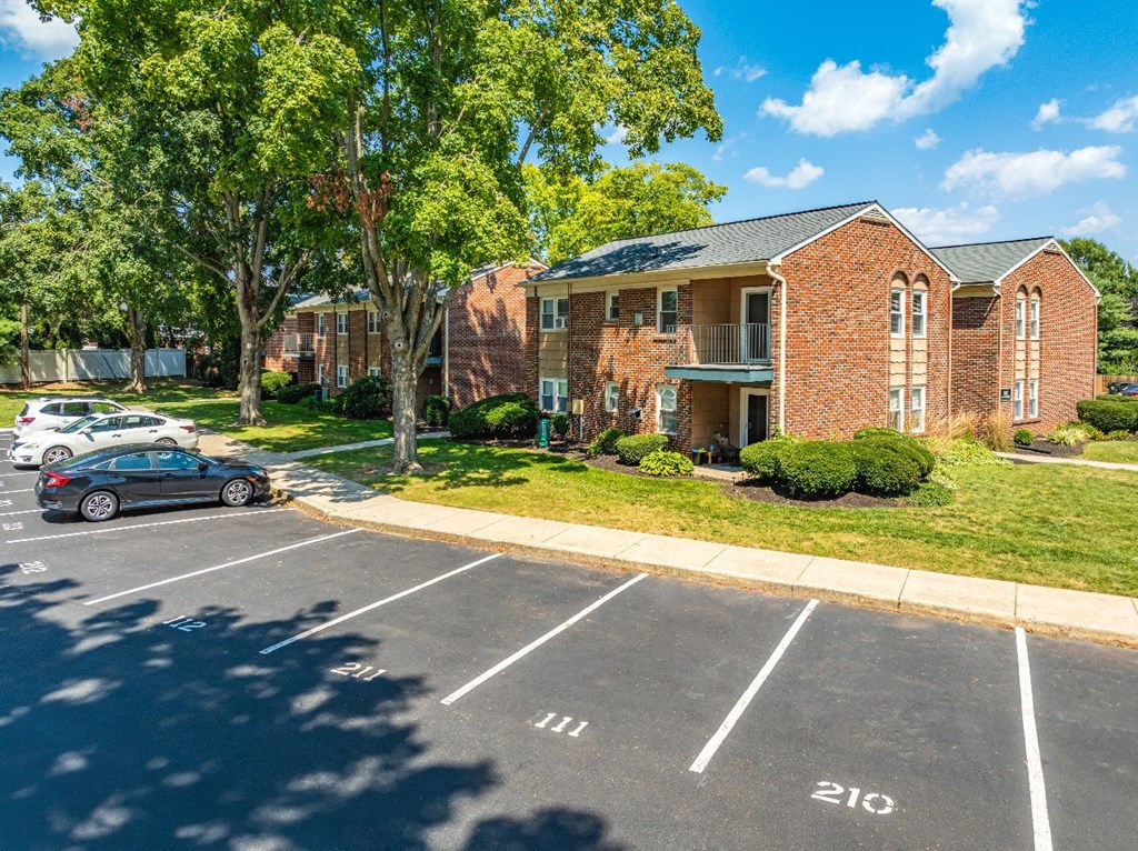 A parking lot with cars parked in spaces 111 and 210.