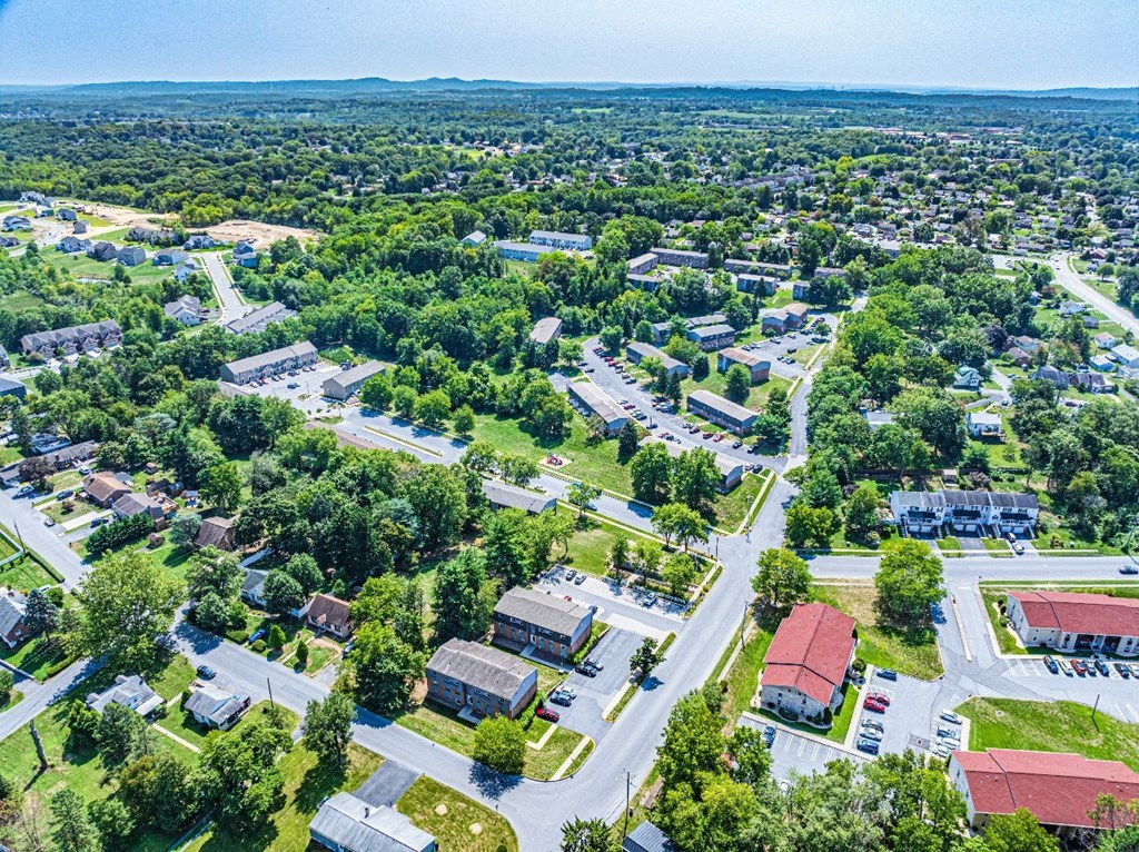 A bird's eye view of a residential area with houses and roads.