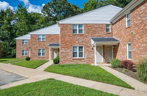 A red brick house with a flag on the front.