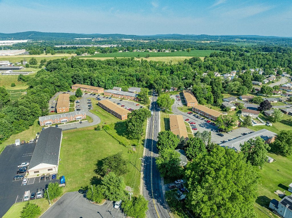 An aerial view of a small town with a large building in the center.