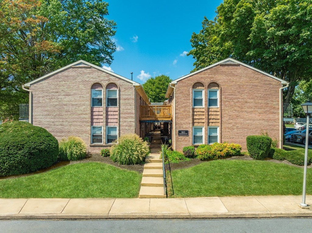 A brick building with a wooden gate in front.