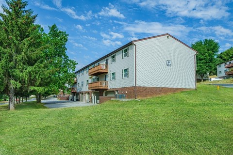 A two-story building with a balcony on the second floor.