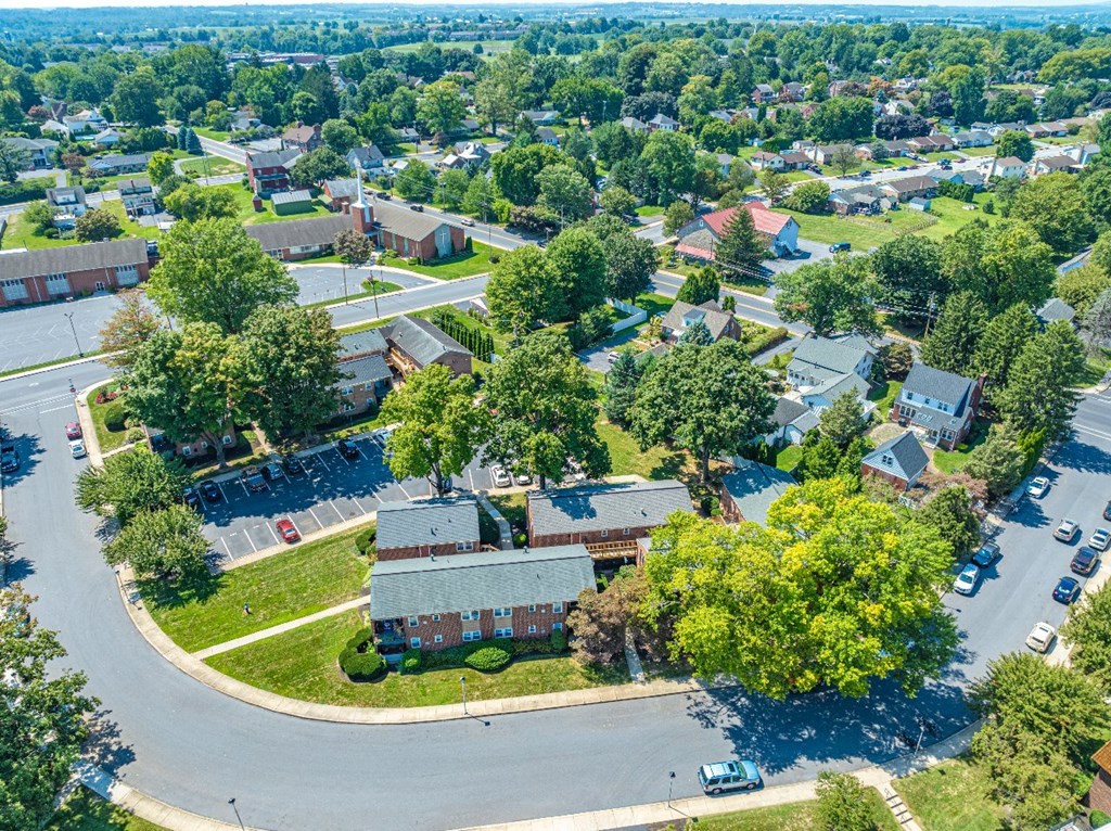 A bird's eye view of a residential area with houses and trees.
