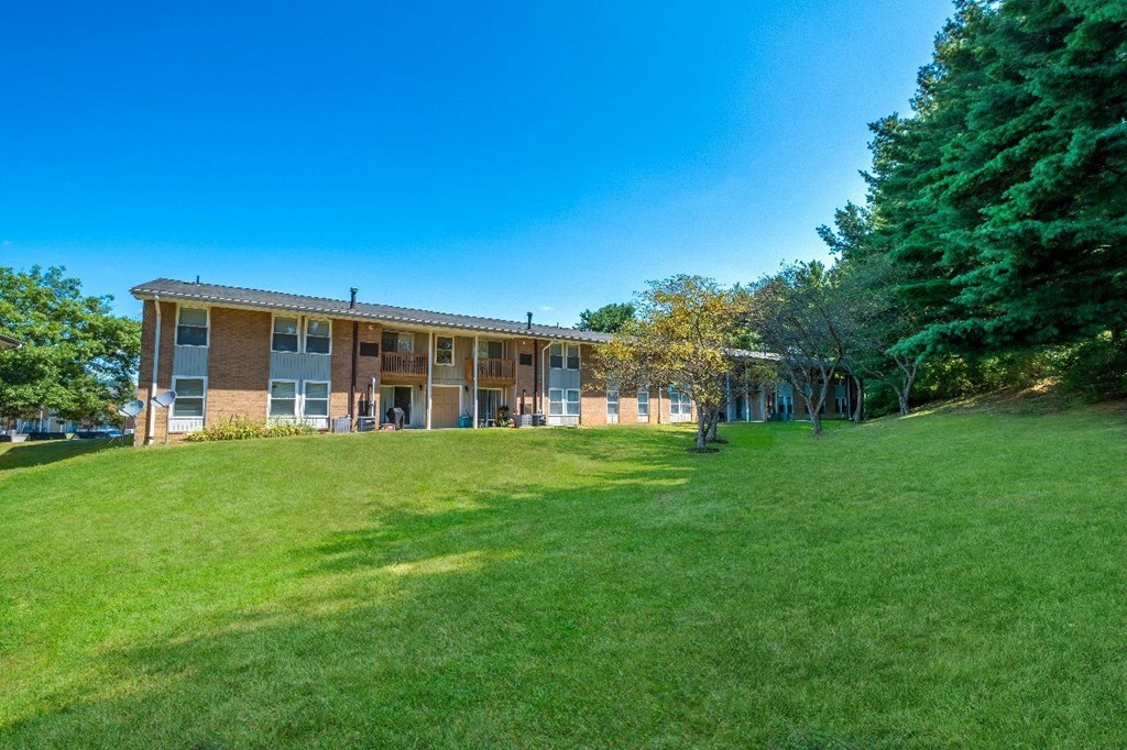 A building with a green lawn in front of it.