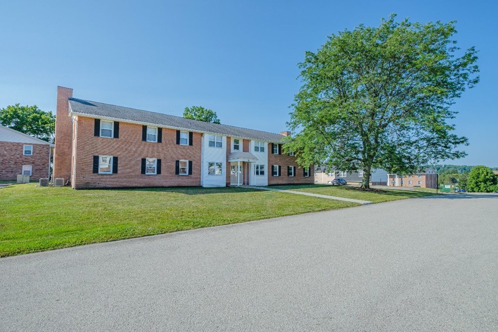 A large building with a tree in front of it.