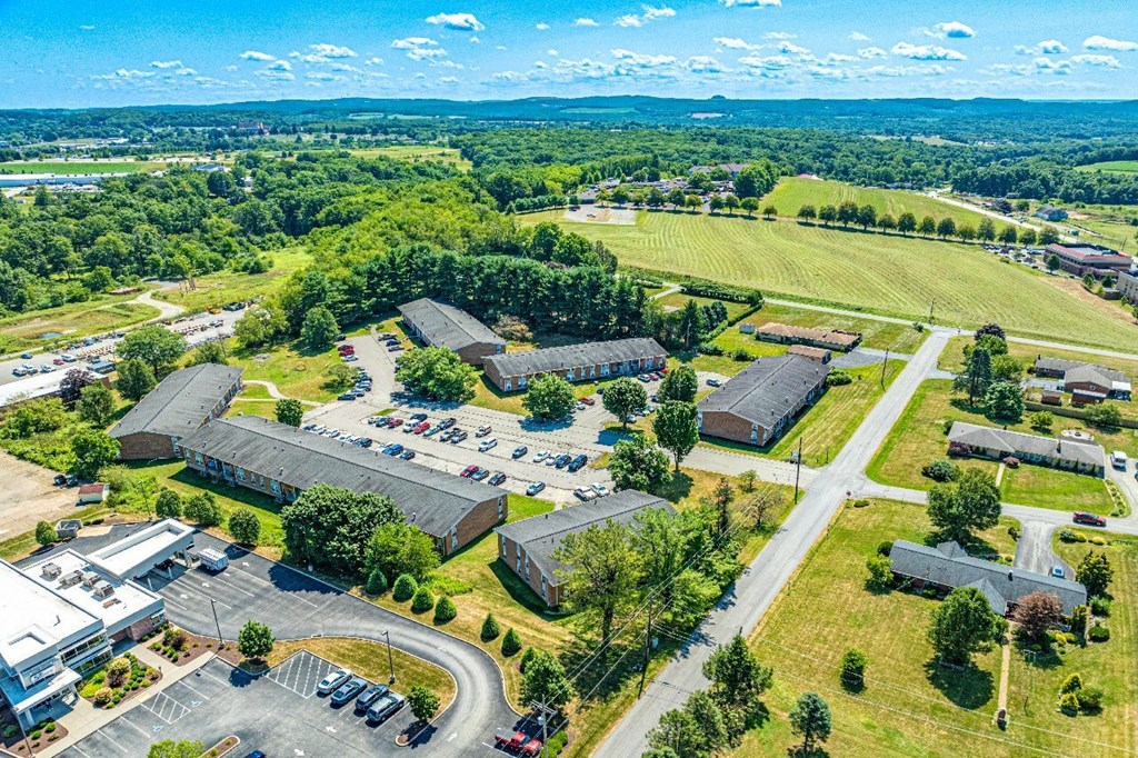 A bird's eye view of a small town with a large building in the center.