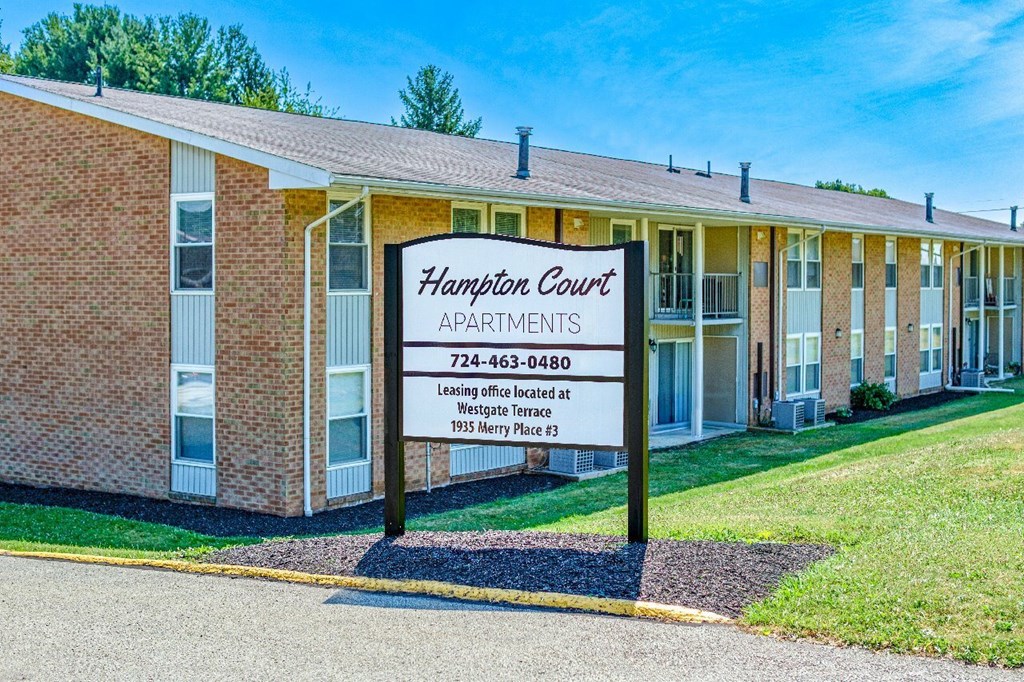 Hampton Court Apartments is a brick building with a sign in front.