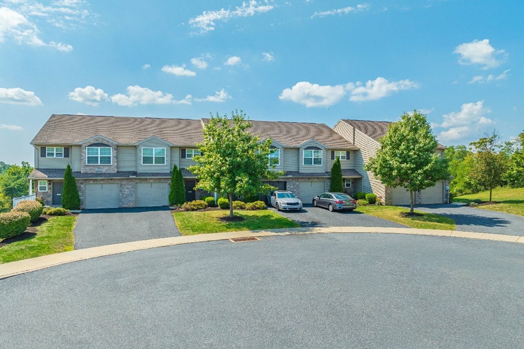 A residential area with houses and cars.