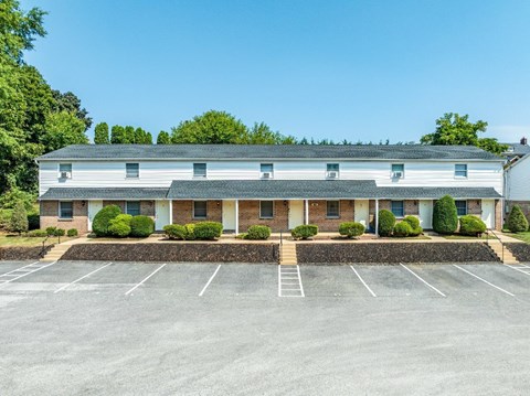 A building with a parking lot in front of it.
