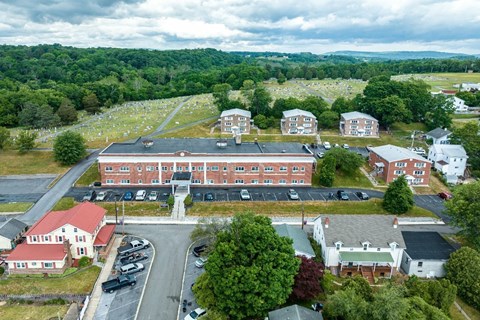 A large building with a parking lot in front of it.