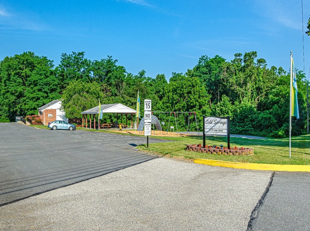 A parking lot with a sign that says "15" and a flag on a pole.