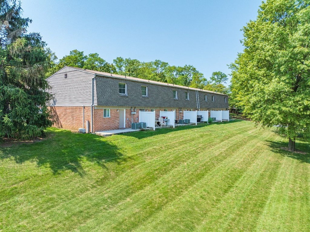 A large house with a lawn in front.