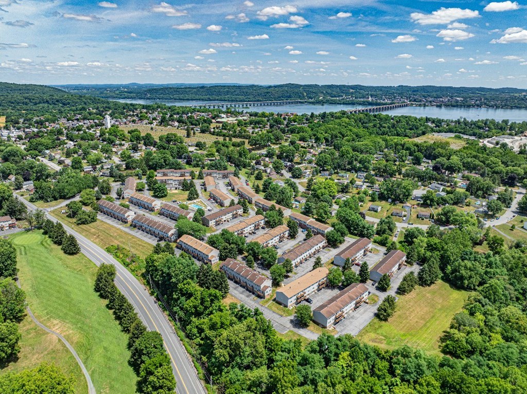 A bird's eye view of a residential area with a road running through it.