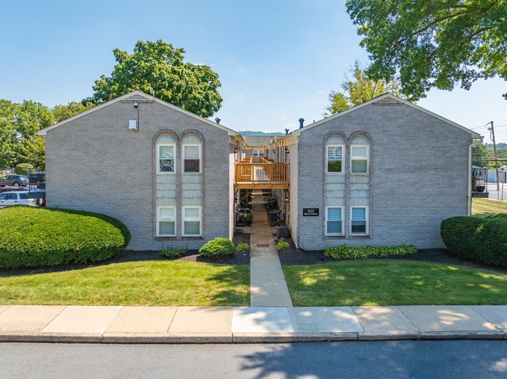 A small building with a wooden door and windows.