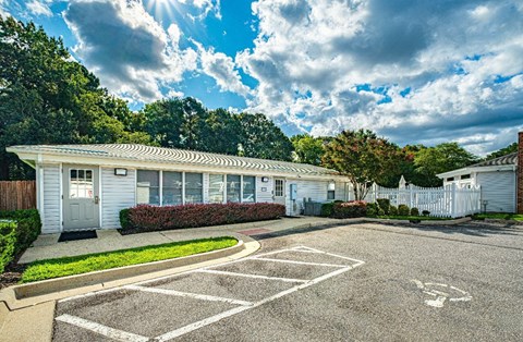 A sunny day at a residential area with houses and a parking lot.