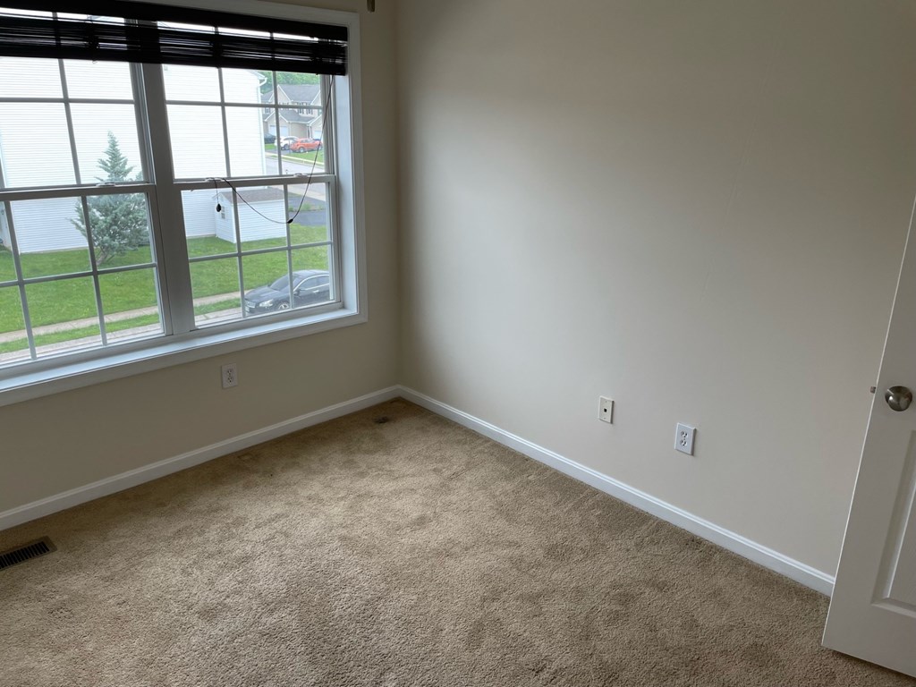 A room with a car parked outside the window.