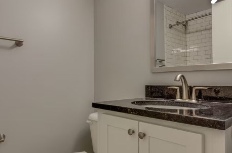 A bathroom with a sink and a mirror.