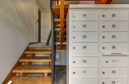 A set of white mailboxes with numbers 11 to 26 are on the right.