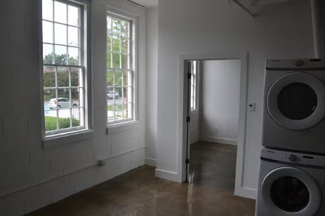 A laundry room with a washer and dryer stacked on top of each other.