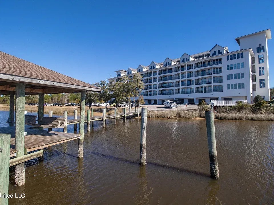 A dock with a building in the background.