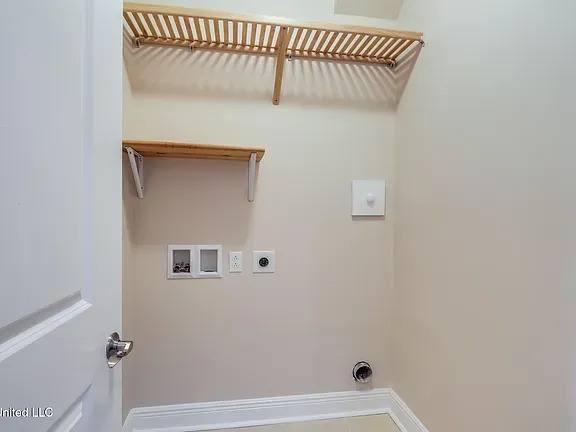 A small, empty room with a white door and a white wall.