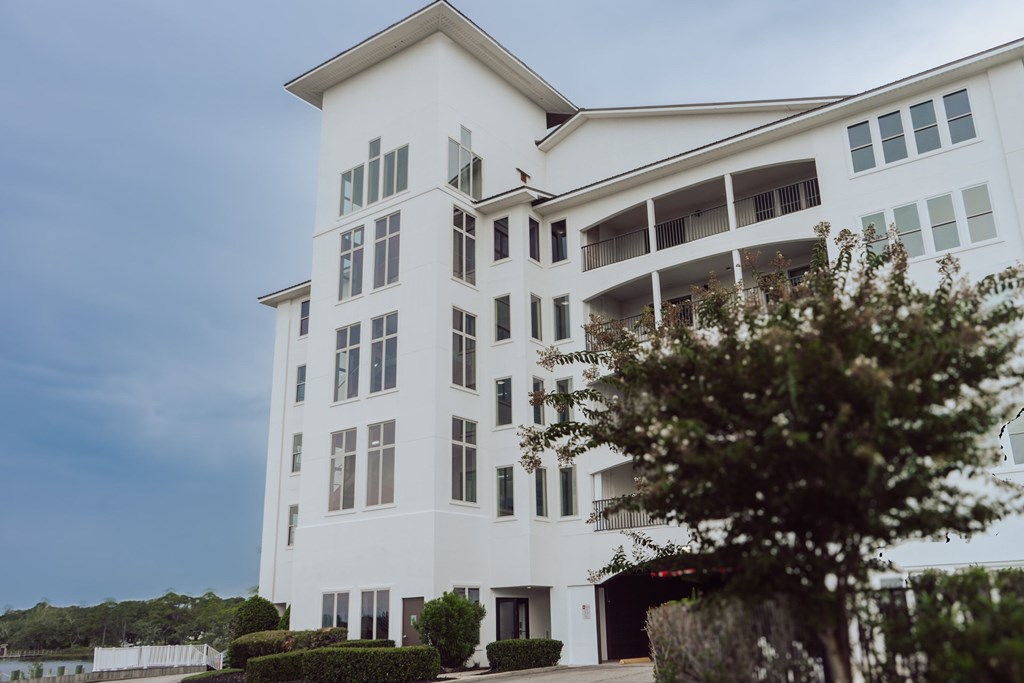 A white building with a balcony on the second floor.