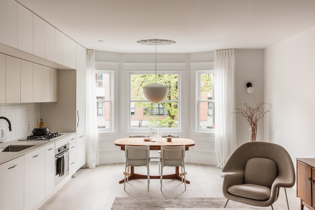 A modern kitchen with a dining table and chairs.